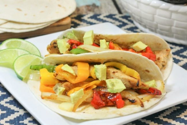 Easy dinner recipe! Toss in chicken, peppers, onions, and seasonings in the crockpot, cook on low, and dinner is done! Crockpot Chicken Fajitas recipe