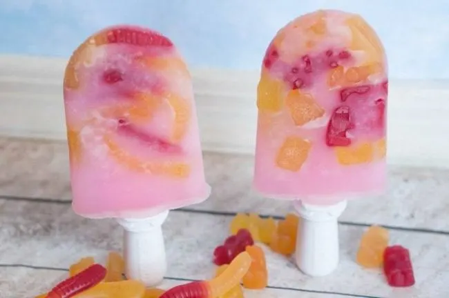 Our favorite summer treat are these tasty gummy cherry popsicles - or with gummy worms or gummy bears! All 3 options are amazing, and completely addicting! Plus, this recipe is SO easy! Make these pops in minutes!