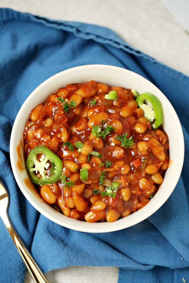 Crockpot barbecue baked beans! So easy to make and even a homemade barbecue sauce recipe! Perfect side dish recipes for any gathering.