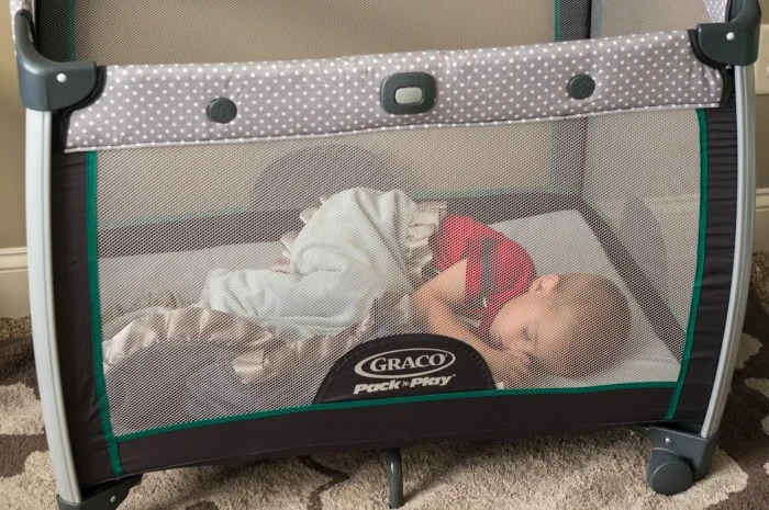 Infant sleeping in pack and play outlet