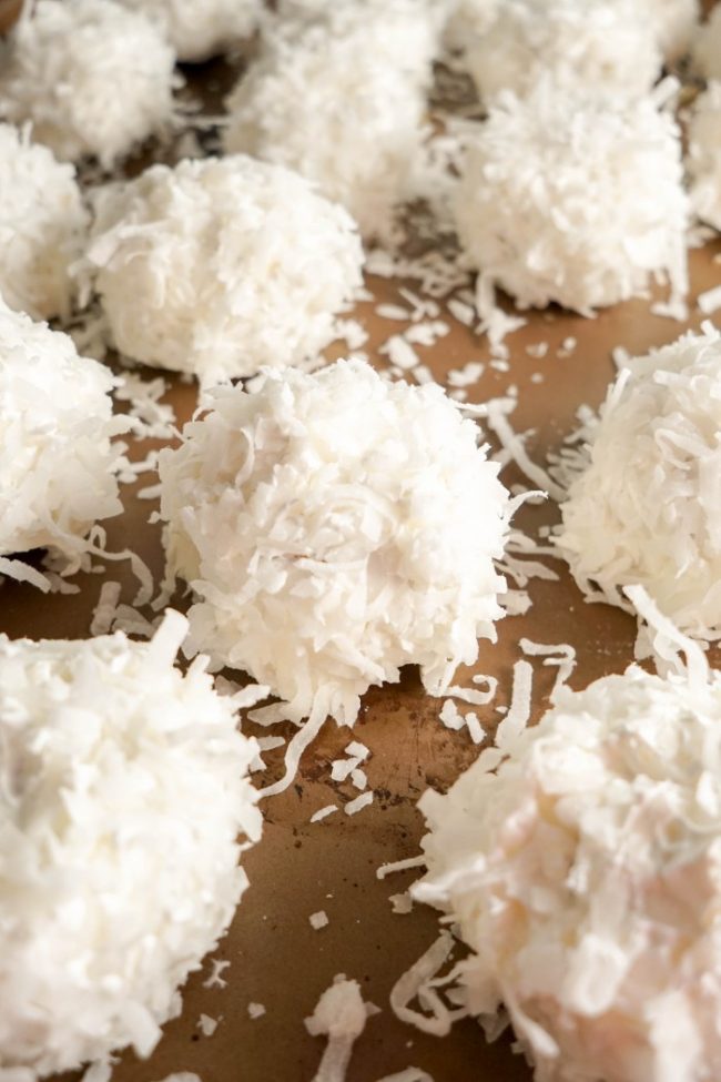 This easy No-Bake Snowball Cookies recipe brings a sweet taste of summer to your holiday festivities. These Hawaiian inspired cookies are so festive and fun with a coconut flake topping and yummy pineapple center. 